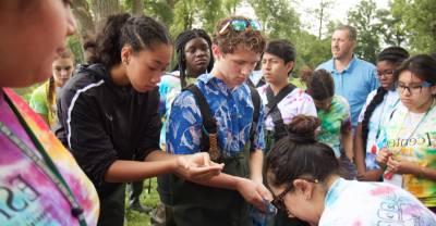 Students gathered working in the field.