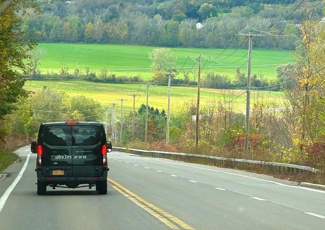 Open roadway with 养 vehicle heading away from camera.